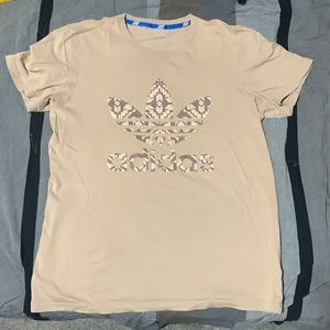 Tan Adidas tee with raised tribal pattern